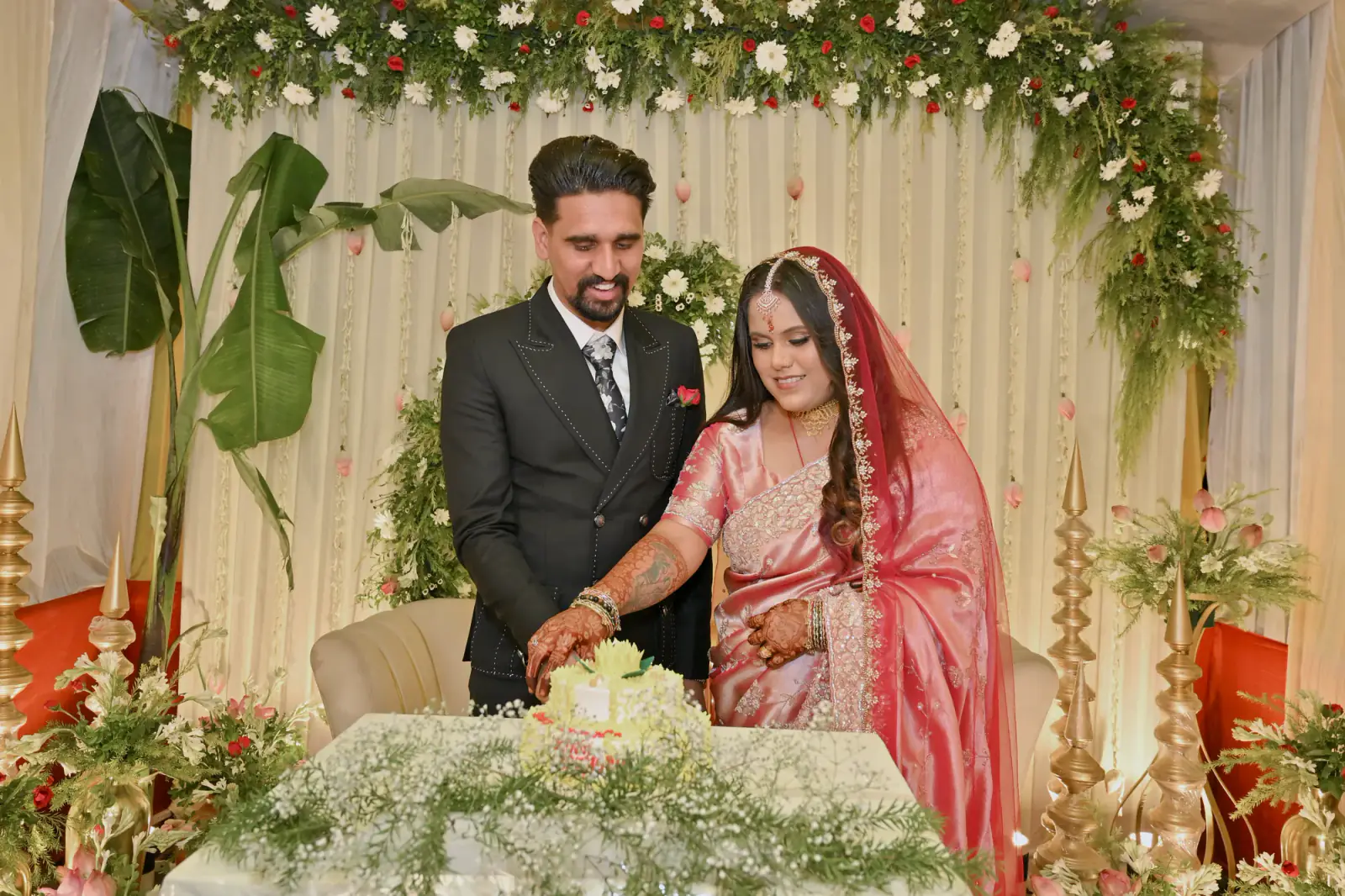 Sumit laughing as they cut the engagement cake