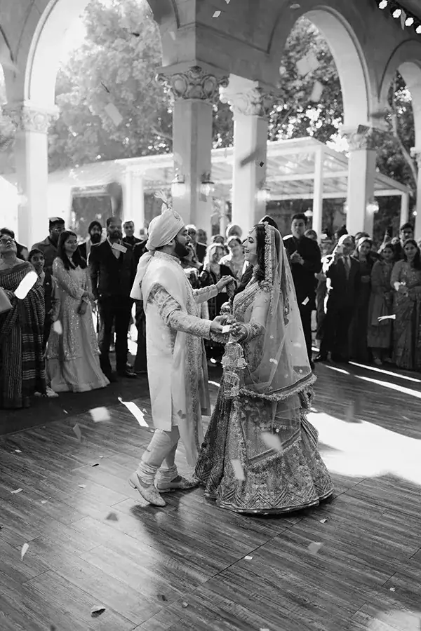 Couple dancing on the floor surrounded by their guests