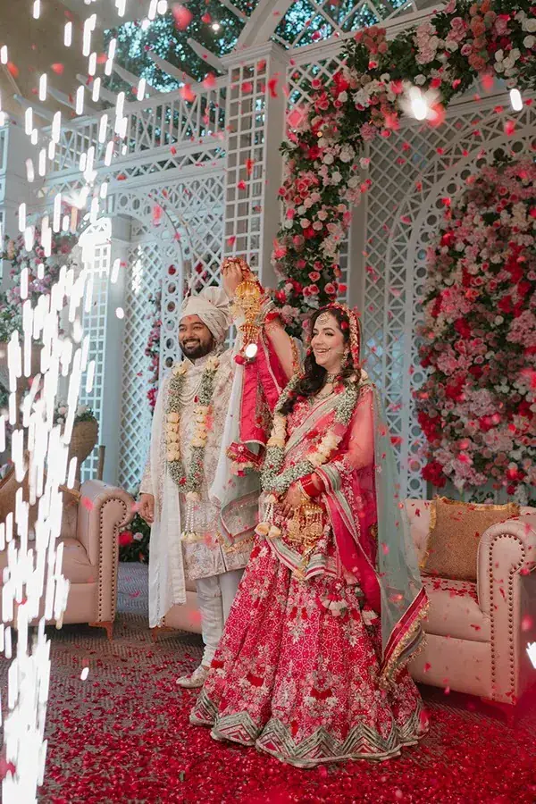 Shikhar and Aanandita on the floral stage as cold-pyro sparklers rise